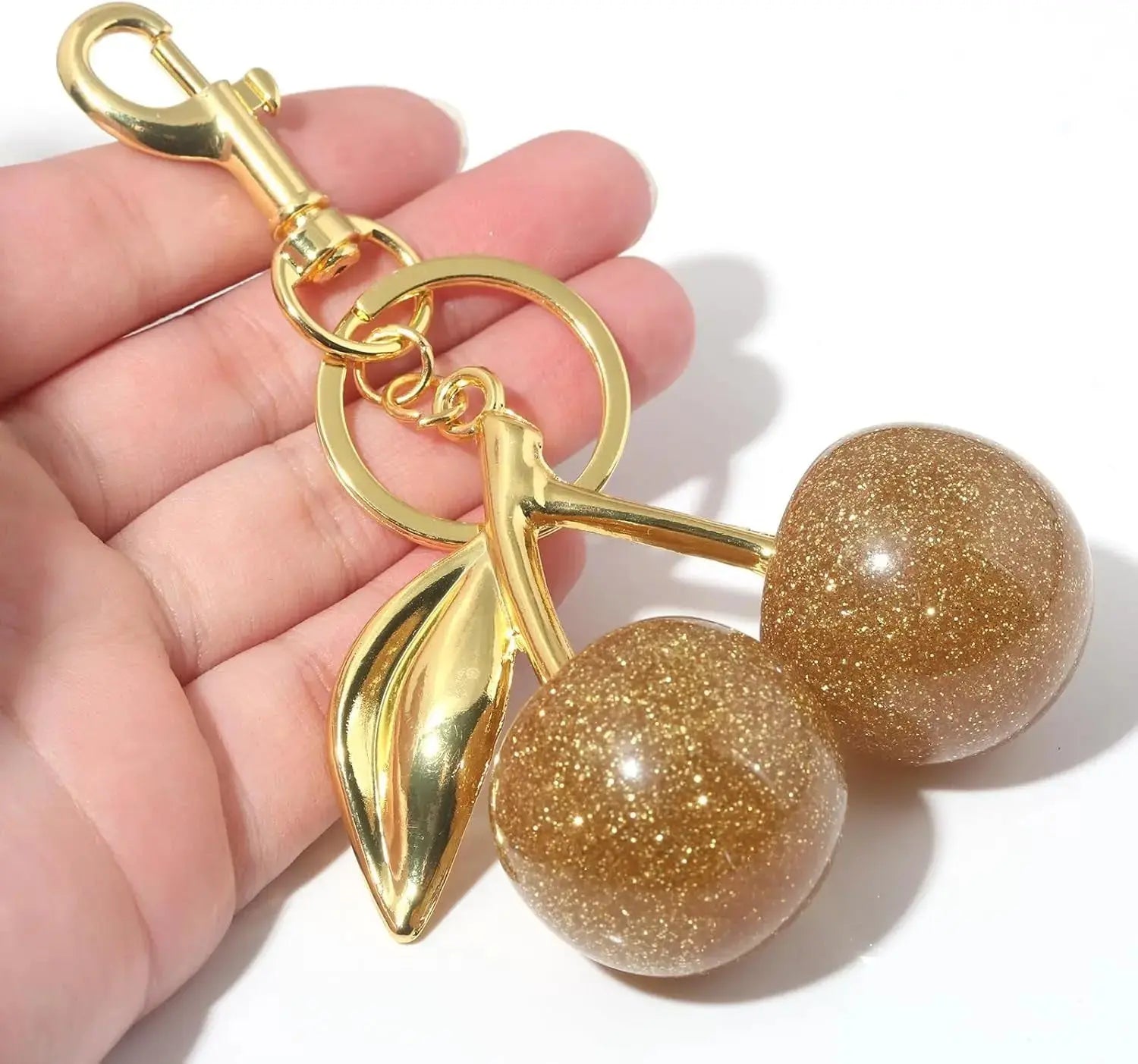 Gold cherry bag charm keychain by Hypes Inventory, cute purse accessory with fruit design for women.