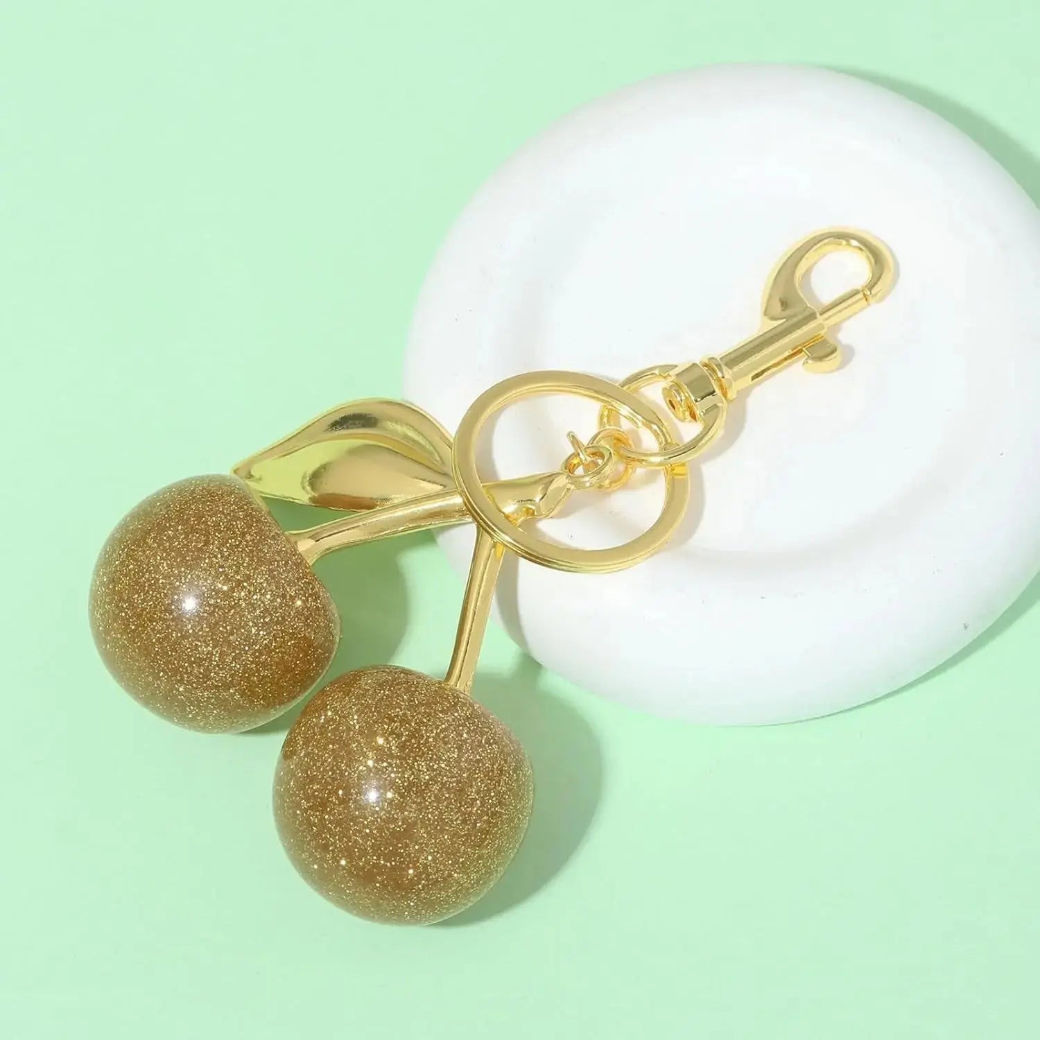 Gold cherry bag charm keychain by Hypes Inventory, a cute fruit accessory for purses and handbags for women.