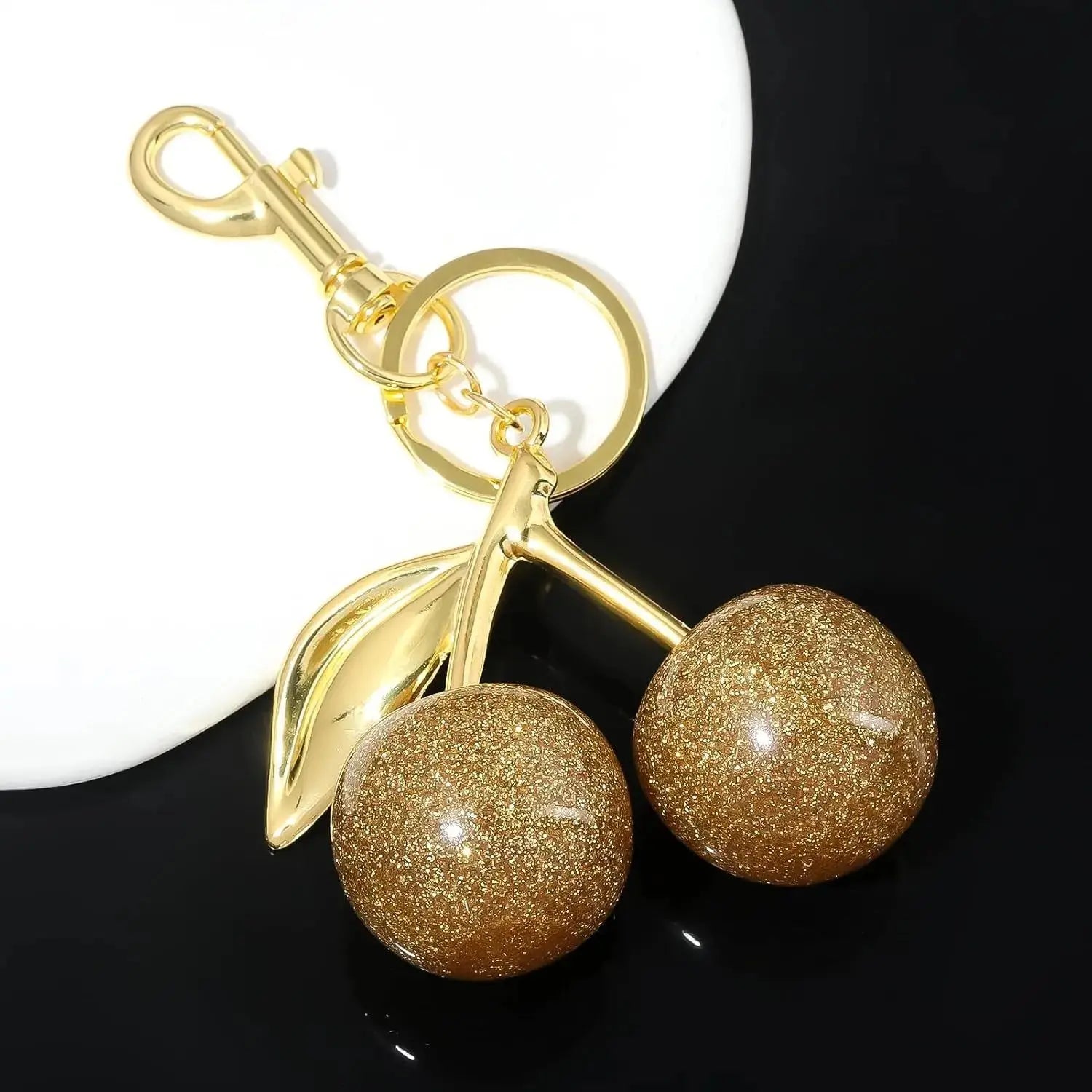 Gold cherry bag charm keychain by Hypes Inventory, a cute purse accessory perfect for women’s handbags and gift ideas