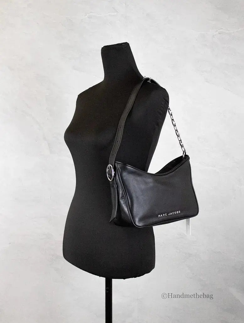 Small black leather hobo bag by Marc Jacobs, featuring a sleek shoulder design and minimalist style with subtle branding.