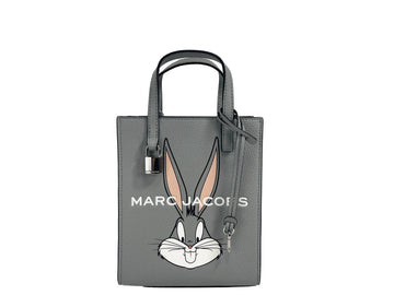 Marc Jacobs Bugs Bunny Looney Tunes leather crossbody bag with adjustable strap and Bugs Bunny graphic design.