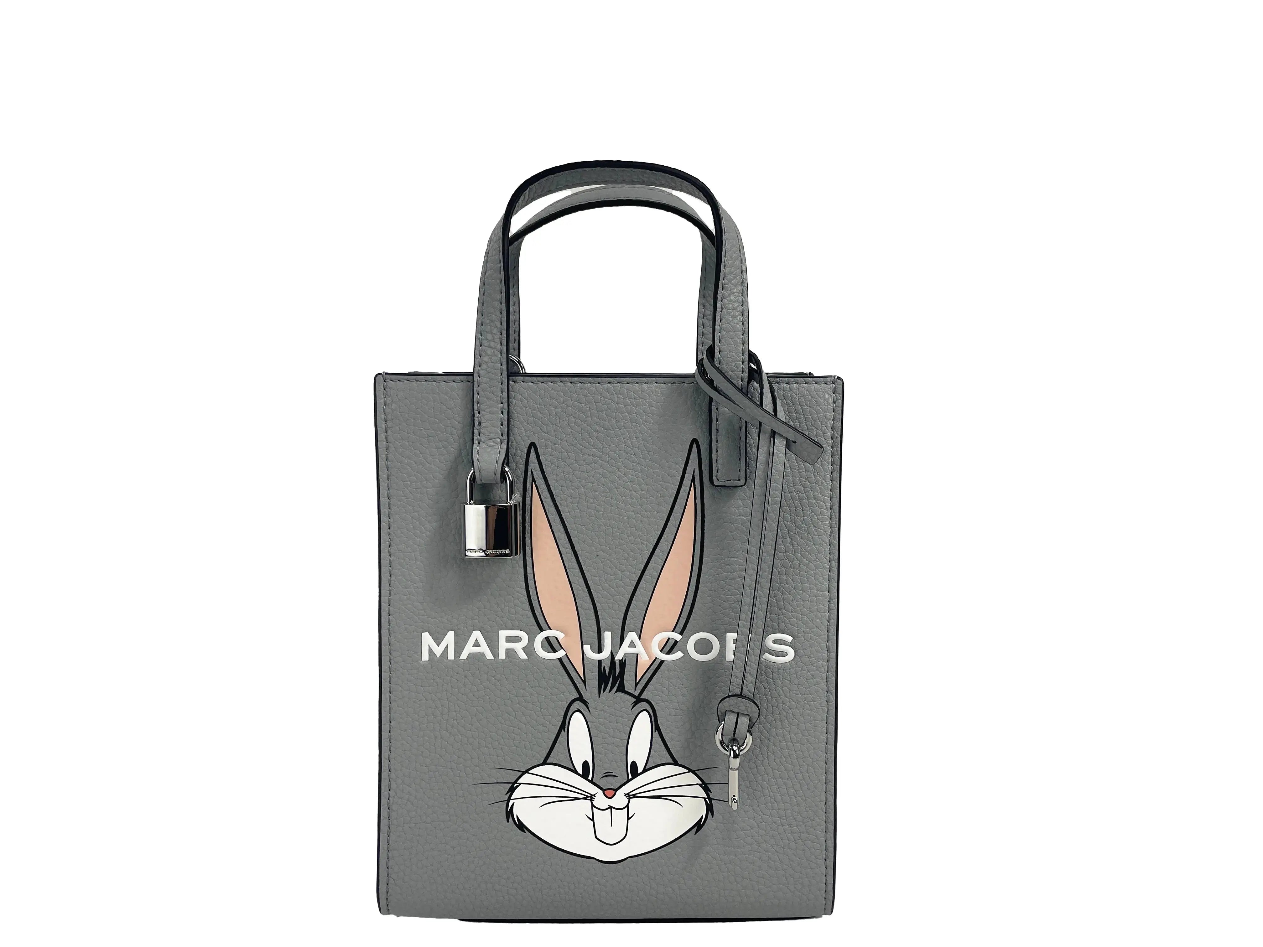 Marc Jacobs Bugs Bunny Looney Tunes leather crossbody bag with adjustable strap and Bugs Bunny graphic design.