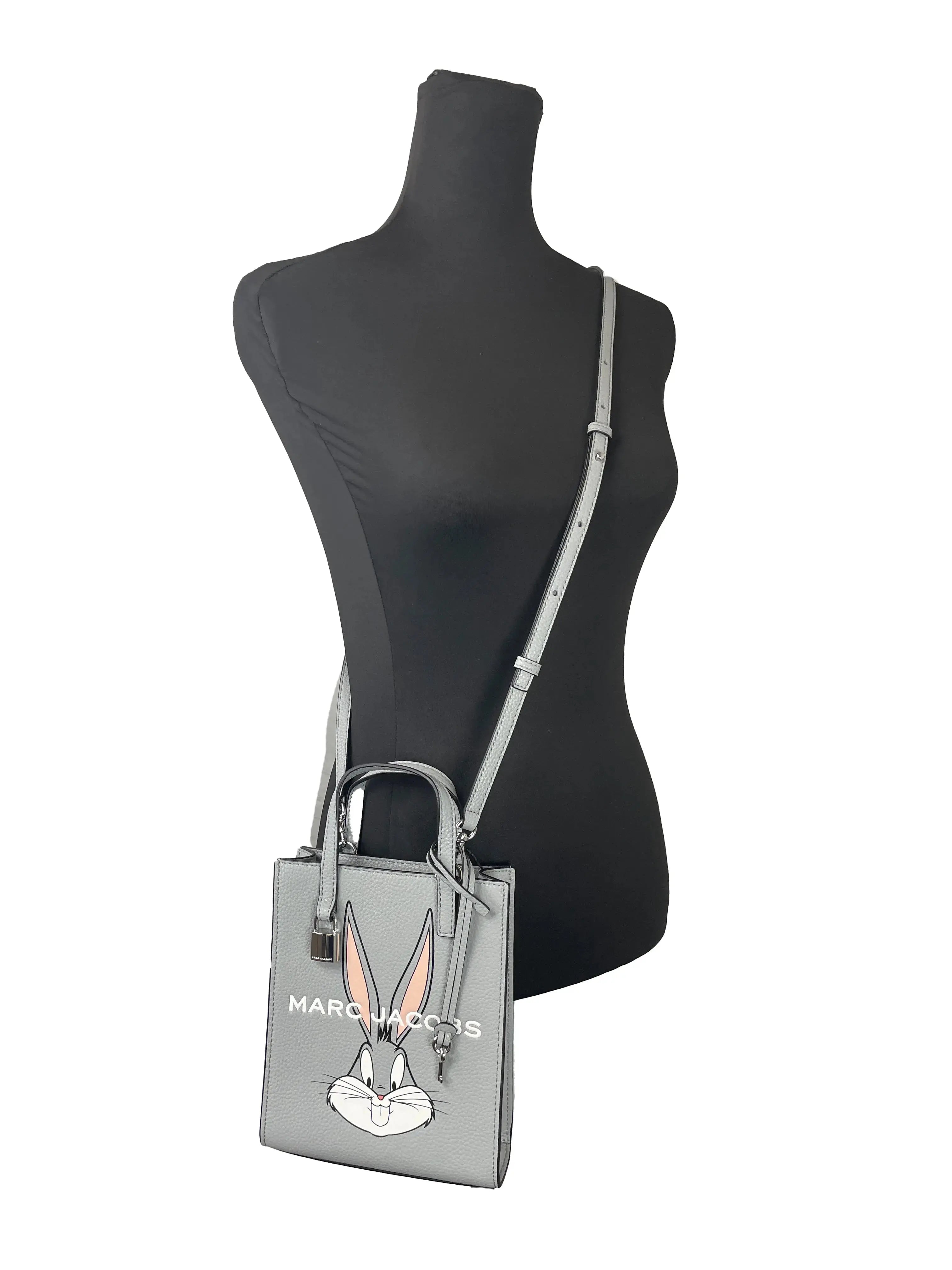 Marc Jacobs Bugs Bunny Looney Tunes leather crossbody bag with adjustable strap and cartoon character print, compact and stylish.