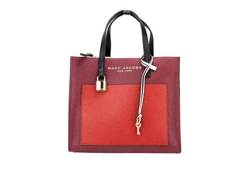 Marc Jacobs Grind Mini leather tote bag in pomegranate color block, stylish crossbody bag with structured design.