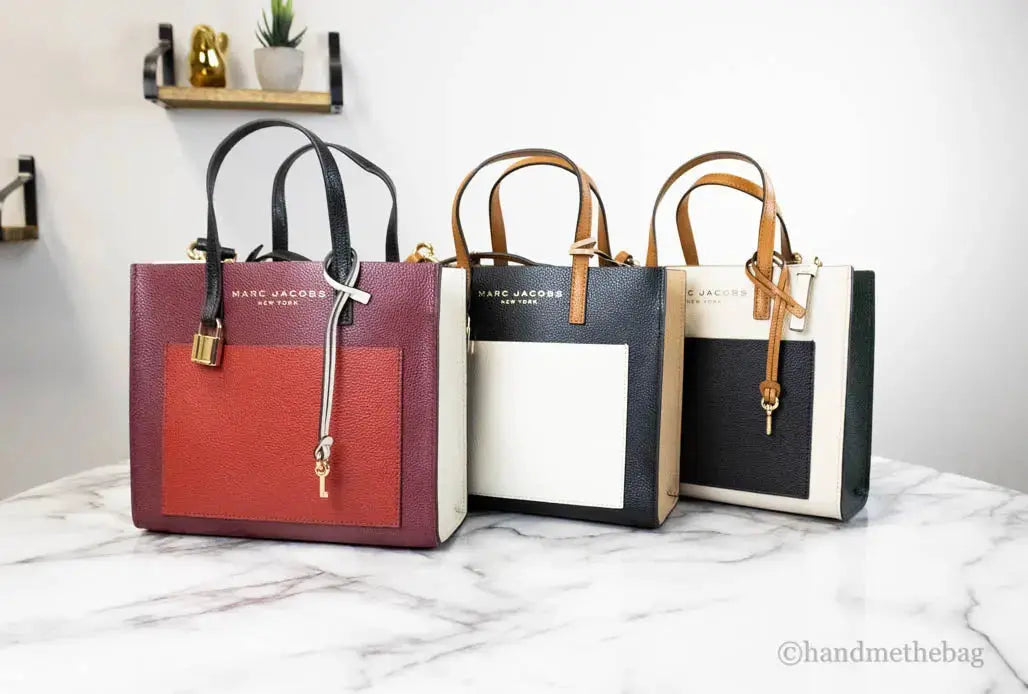 Marc Jacobs Grind Mini leather tote bag in pomegranate color with color block design, featuring a versatile crossbody style.
