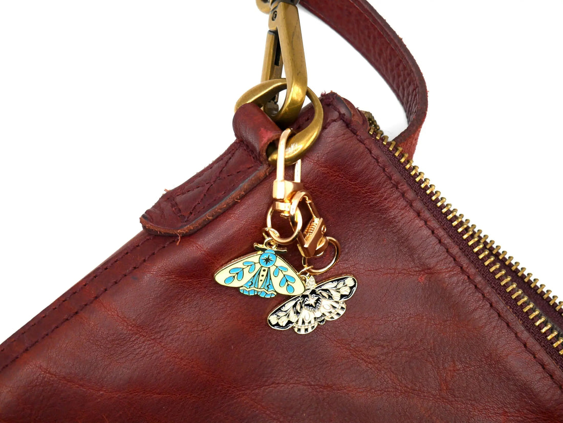 Celestial moth metal keychain and bag charm with butterfly design, from Why Begin, perfect as an aesthetic accessory.