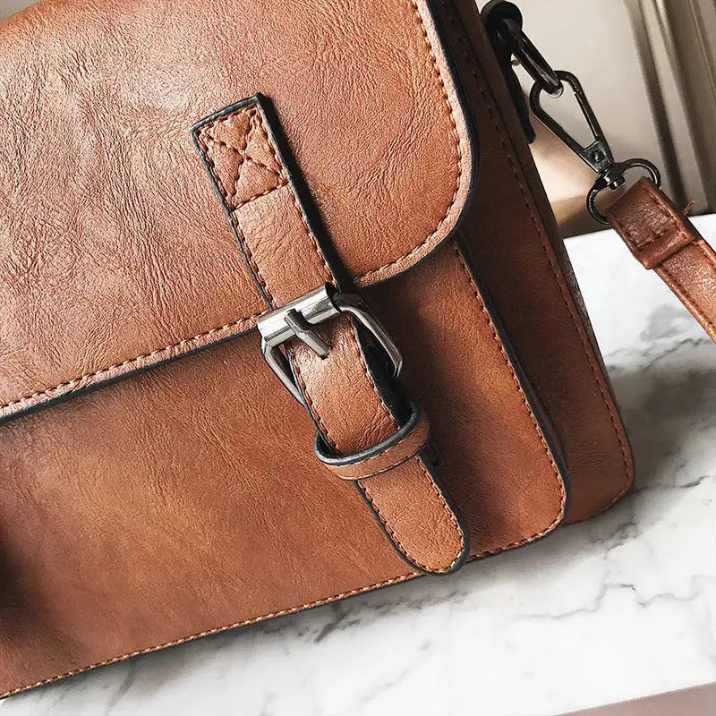 Hypes Inventory women's tassel crossbody bag with square shoulder design, featuring a stylish and functional handbag for everyday use.