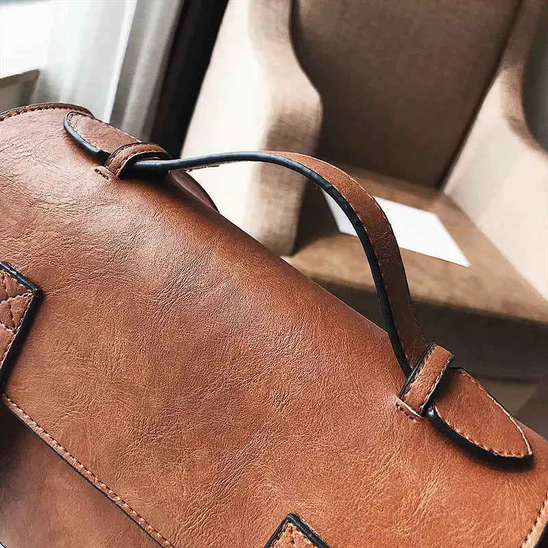 Hypes Inventory tassel crossbody bag for women with square shoulder design, featuring a stylish, compact handbag with tassel detail.