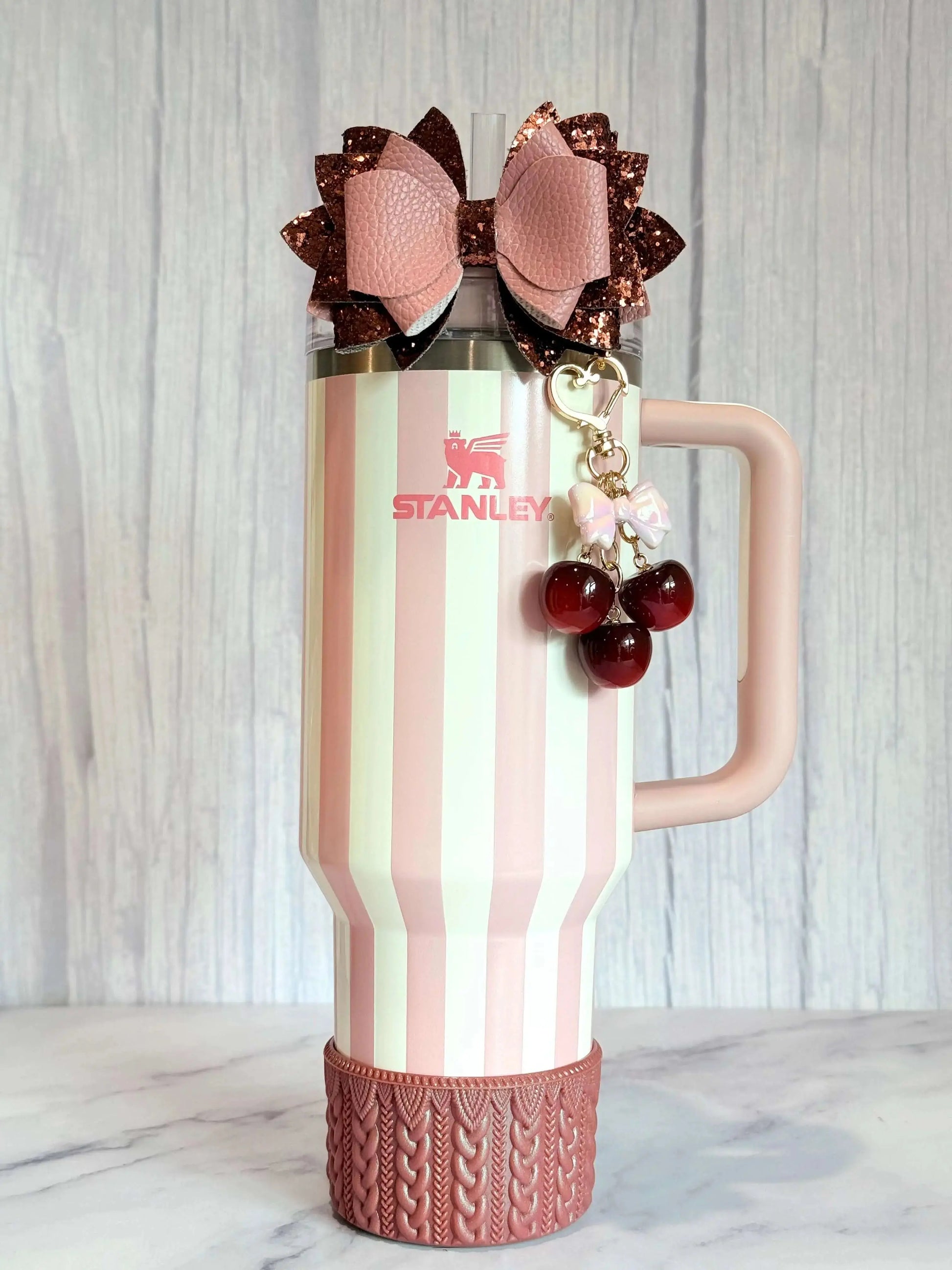 Deluxe Cherry Charm - Tumbler Handle Charm attached to a striped Stanley tumbler with a decorative bow.