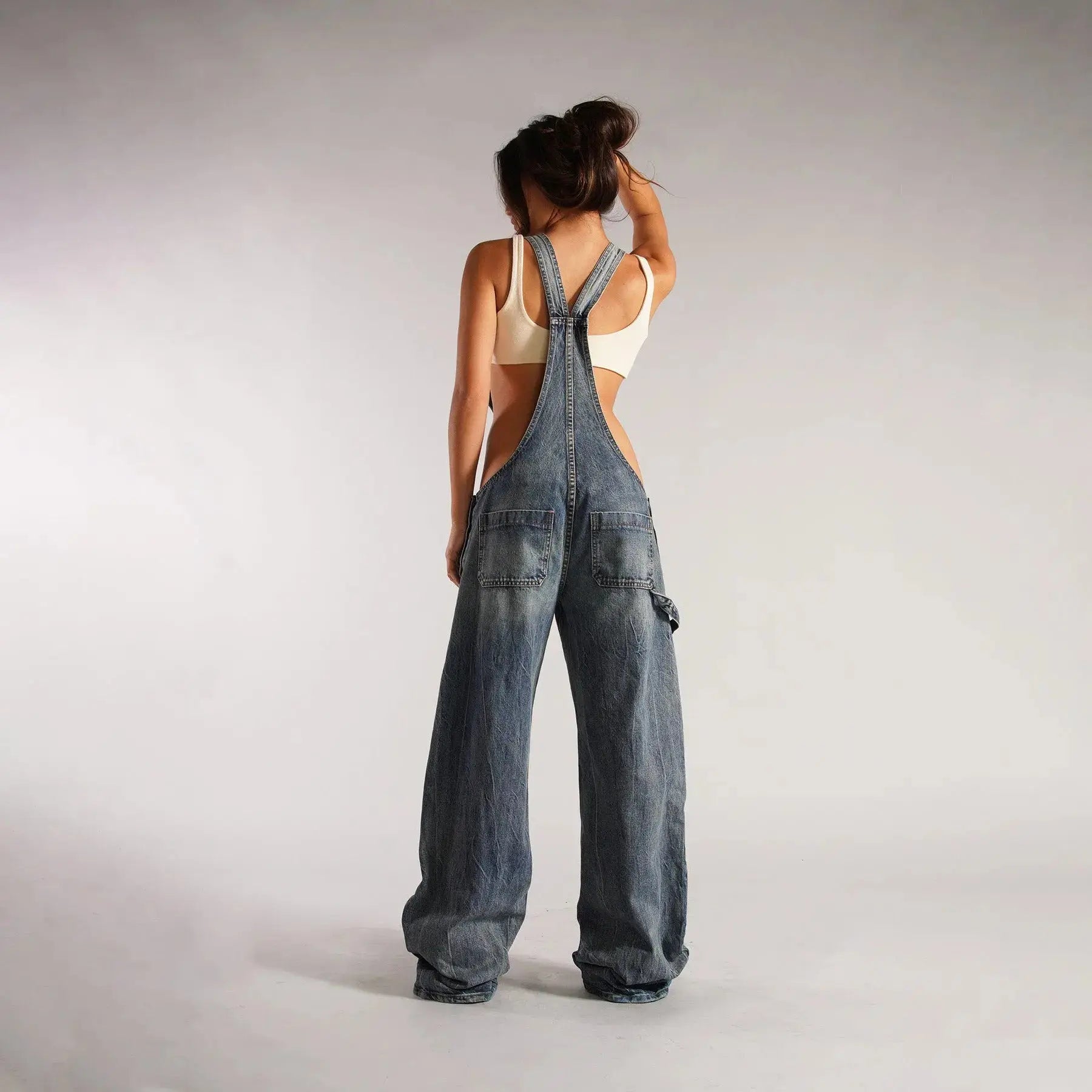Black Y2K denim overalls for women by Flairé™, loose fit zip front jumpsuit with pockets and casual style.