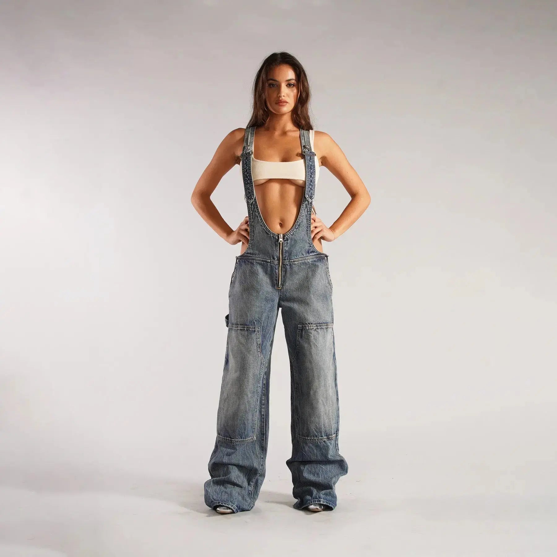 Black Y2K denim overalls for women by Flairé™ with a zip front, loose fit, and front pockets, styled as a casual jumpsuit.