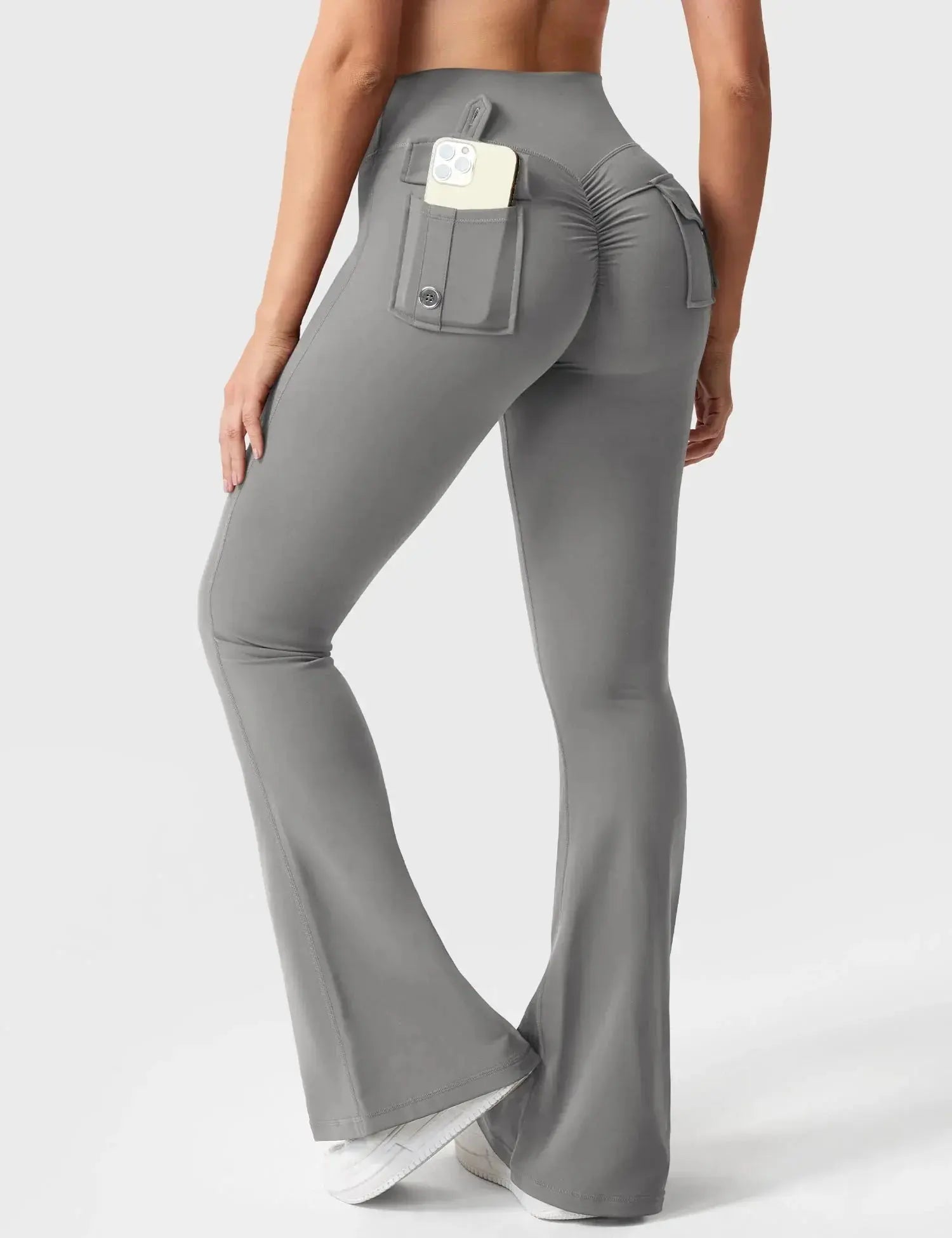 Light gray Flairé™ 30-inch high-waisted flare leggings with pockets, designed for yoga and athleisure, shown on a model.
