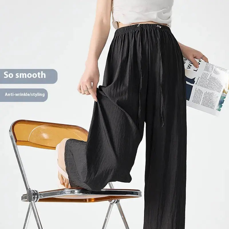 Dark gray Flairé™ high waist wide-leg pants for women, relaxed fit minimalist trousers with a comfortable, stylish silhouette.