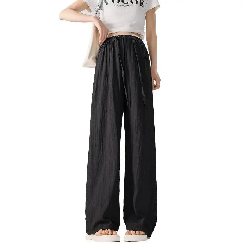 Dark gray Flairé™ high waist wide leg pants for women, relaxed fit minimalist trousers with a stylish, flowing silhouette.