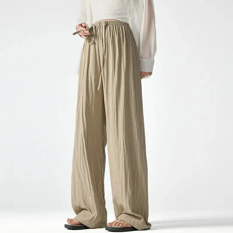 Dark gray Flairé™ high waist wide leg pants for women, relaxed fit, minimalist design, made from comfortable, flowy fabric.
