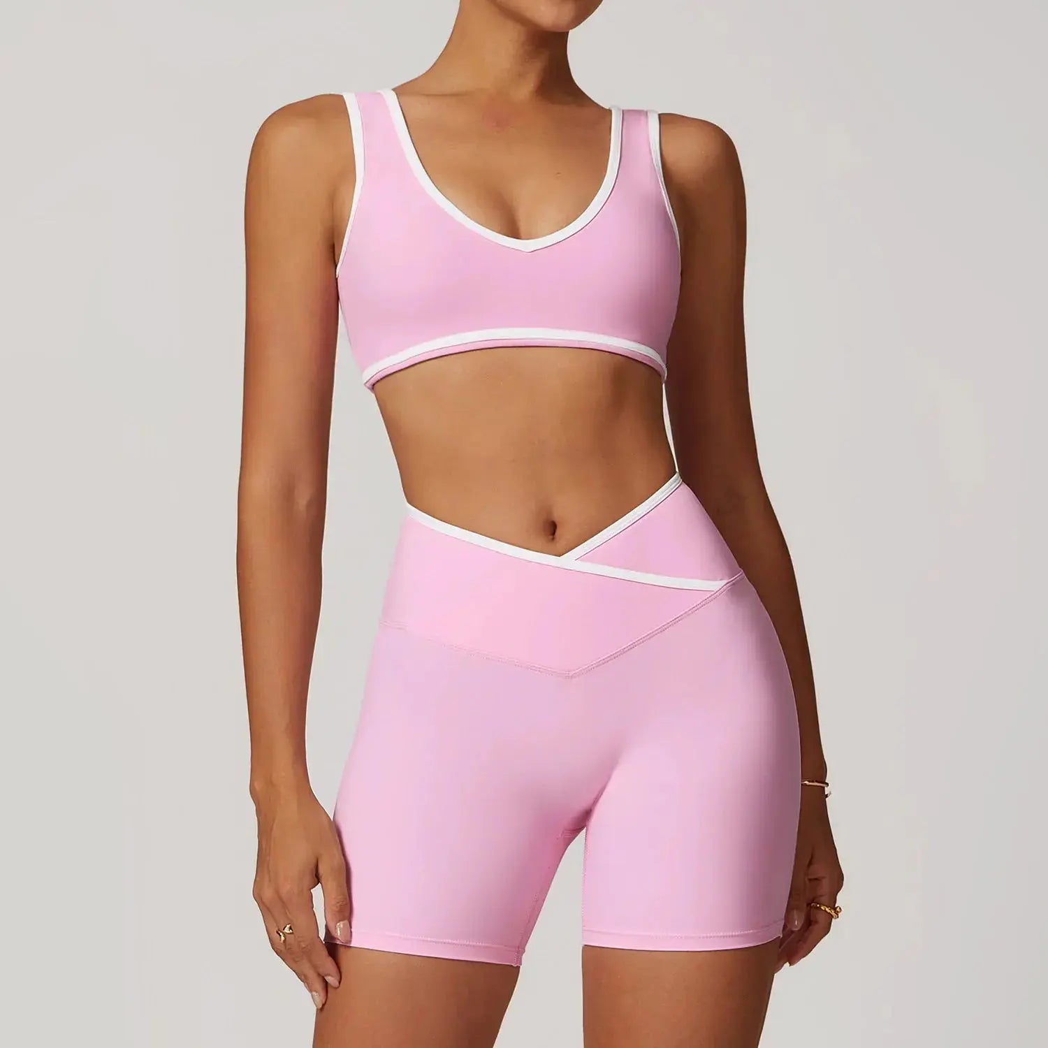 Women wearing Flaire™ Cross High Waist Yoga Set by Hypes Inventory, showcasing a fitted black workout top and matching leggings.