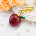 Apple-shaped keychain bag charm by Hypes Inventory, cute and aesthetic purse accessory for women to decorate handbags.