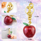 Hypes Inventory Apple-shaped keychain bag charm attached to a handbag, featuring a cute and colorful aesthetic accessory for women.