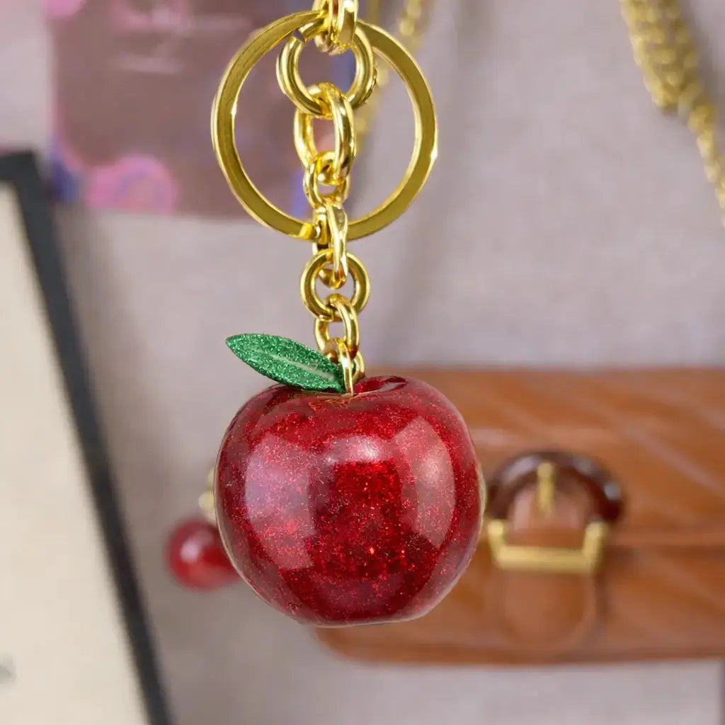 Hypes Inventory Apple-shaped keychain bag charm for handbags, featuring a cute, aesthetic purse accessory for women.