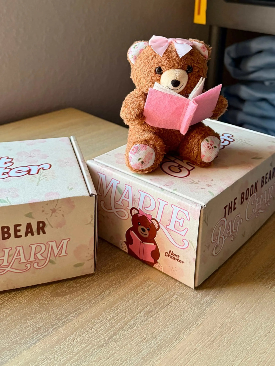 Next Chapter Book Bear plush bag charm featuring a cute bear design, ideal for keys and bags.