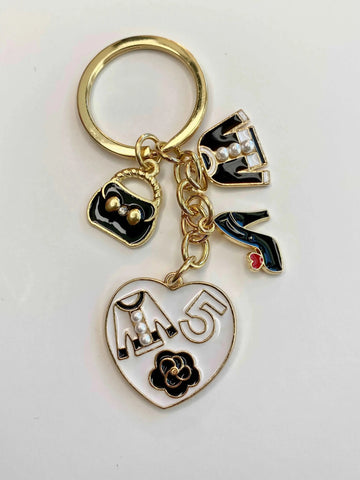 The Fabulous Planner bag and shoe keychain charm hanging from a keyring, showcasing detailed miniature accessories.