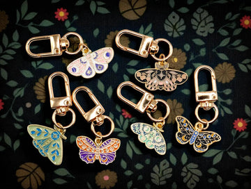 Celestial moth metal keychain and bag charm with butterfly design, from Why Begin, perfect as an aesthetic accessory.